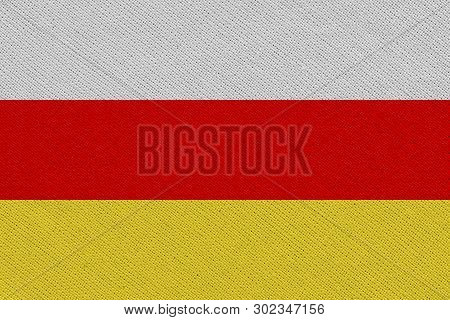 South Ossetia Fabric Flag. Patriotic Background. National Flag Of South Ossetia