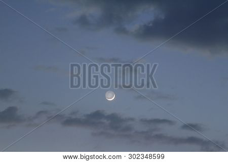 New Moon In The Daytime On The Day Blue Sky.