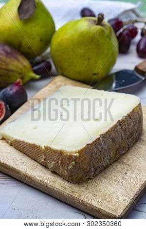 Piece Of French Cheese Tomme De Brebis Made From Sheep Milk Served As Dessert With Fresh Figs And Pe