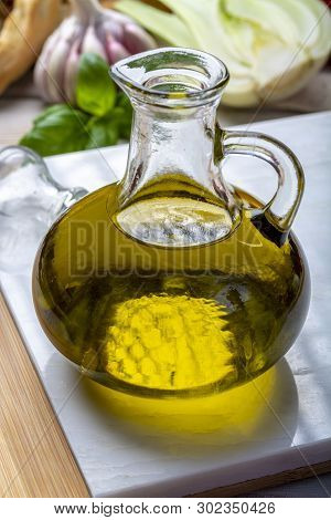 Virgin Natural Olive Oil Is Glass Bottle, Served With Traditional Mediterranean Food