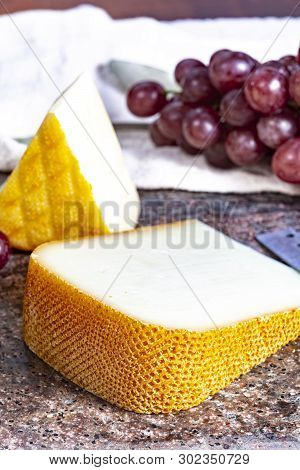 Pieces Of French Yellow Cheeses, Pur Brebis Sheep Melk Cheese Fron Pyrenees And Saint Paulin Creamy,