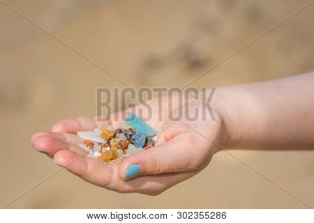 Little Girl Holding Small Tiny Harmful Plastic Beads Collected On The Beach In Zante, Zakynthos, Gre