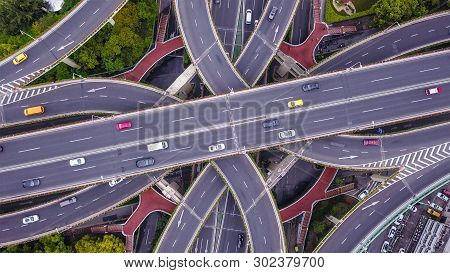 Aerial View Of Highway Junctions Shape Letter X Cross. Bridges, Roads, Or Streets With Trees In Tran