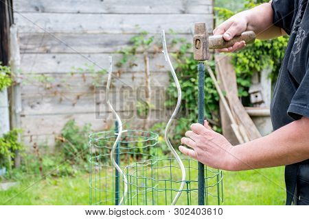 Gardening Handman Working In Garden To Preparing Garden With Cutting,and Tight Plastic With Grill To