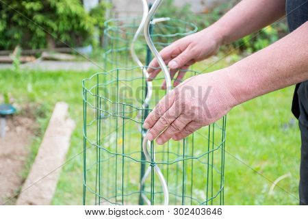 Gardening Handman Working In Garden To Preparing Garden With Cutting,and Tight Plastic With Grill To