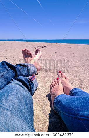 Vacation Holidays. Man And Woman Feet Closeup Relxing On Beach On Sunbed Enjoying Sun On Sunny Summe