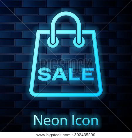 Glowing Neon Shoping Bag With An Inscription Sale Icon Isolated On Brick Wall Background. Handbag Si