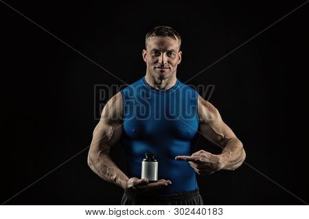 Handsome Bodybuilder Man Or Sexy Muscular Smiling Guy In Blue Vest With Athlete Body, Torso And Ches