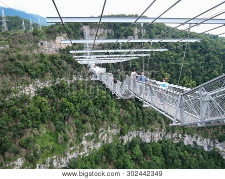 Sochi, Russia - June 10, 2016: People Dared To Walk On The Suspension Bridge Itself