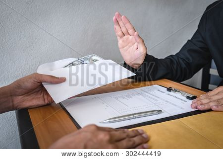 Anti Bribery And Corruption Concept, Business Man Refusing And Don't Receive Money Banknote In Envel