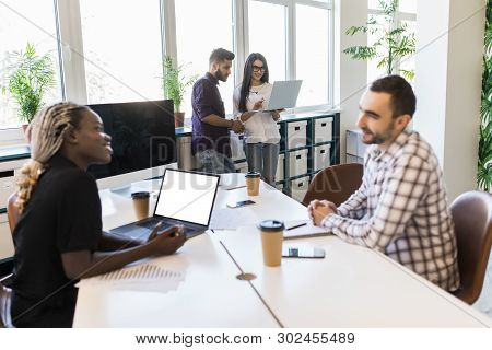 Diverse Colleagues Sitting Talking On Business Training With Coach, Multiracial Team Employees Discu