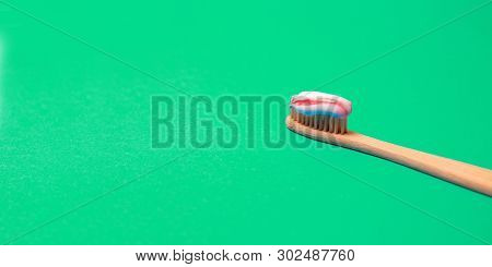 Bamboo Natural Toothbrush With Natural Bristles On A Greenbackground. Free Copy Space. Medical Conce