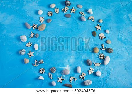 Sea Stones And Wooden Figures Of Fish, Octopuses, Crabs, Jellyfish, Anchors And Hand Wheels, Laid Ou