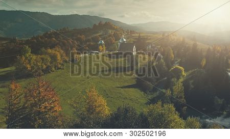 Sunset Mountain Village Church Scenery Aerial View. Panoramic Autumn Wild Nature Hill Landscape Overview. Rural High Meadow Unpolluted Environment, Tourism Concept