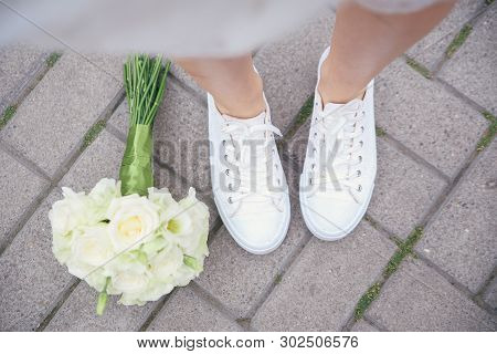 Wedding Shoes And Bouquet With Roses. Wedding