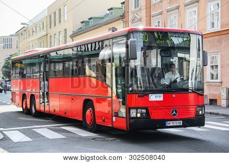Salzburg, Austria - July 28, 2014: Red Suburban Bus Mercedes-benz O550 Integro L In The City Street.