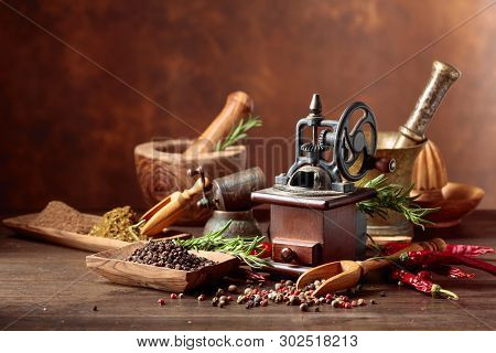 Vintage Pepper Mill With Various Peppers And Spices. Old Pepper Mill With Kitchen Utensils, Spices A