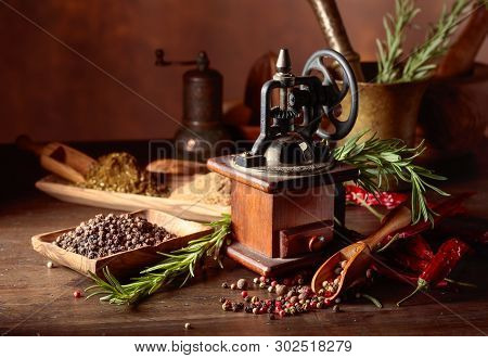 Vintage Pepper Mill With Various Peppers And Spices. Old Pepper Mill With Kitchen Utensils, Spices A