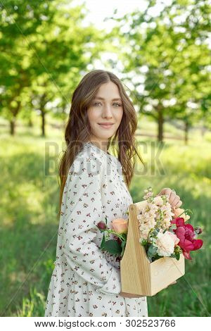 Half Portrait Of A Charming Positive Woman Dressed In Long White Summer Dresses With A Happy Smile O