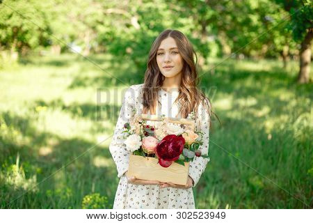 Half Portrait Of A Charming Positive Woman Dressed In Long White Summer Dresses With A Happy Smile O