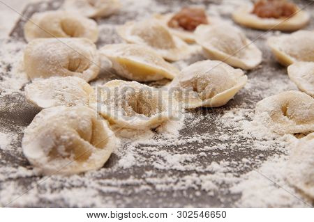 Raw Yellow Dumplings, Flouted Lie On Wooden Brown Board
