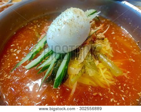 Bibim Naengmyeon Or Spicy Cold Buckwheat Noodle Mixed With Cucumber Fermented Vegetable On Top With 