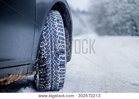 Wheel With Spikes On A Winter Road. Winter Road. Snow Road. Car On The Winter Road. Footprints In Th