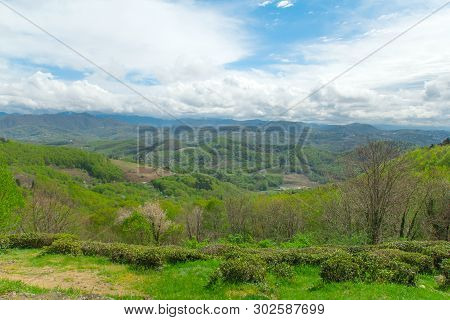 Scenic View On Mountains,green Hills And Cloudy Sky