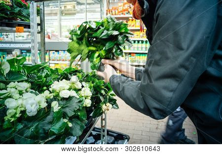 Frankfurt, Germany - Apr 13, 2019: Side View Of Elegant German Woman Buying Diverse Flowers And Hous