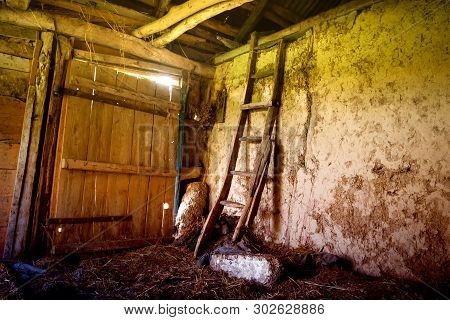 Old Abandoned Barn In The Village. Inside The Retro Staircase Leads To The Attic. Horizontal Frame. 