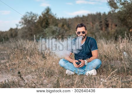 Bearded Vaper Blows Up A Couple An Vape. Health Concept.