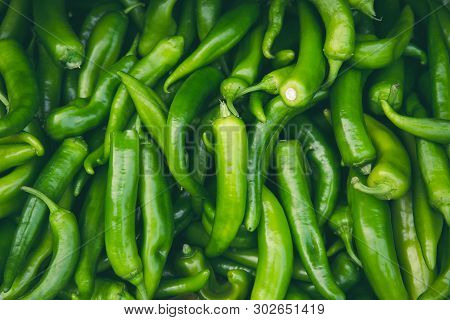 Fresh Hot Green Chilli Pepppers In The Market As A Background. Spicy Food Ingredient