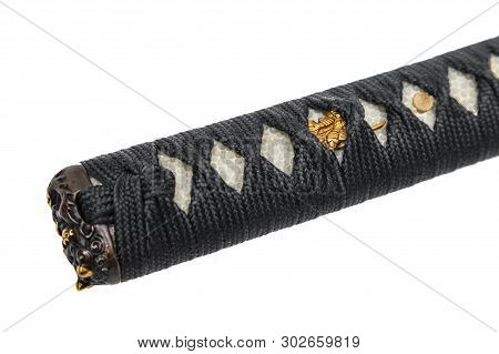 Close-up Tsuka : Handle Of Japanese Sword Wrapped By Black Silk Cord With Gold Fitting Isolated In W