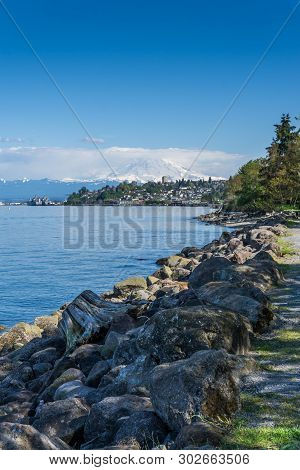 Majestic Mount Rainier Towers Over The Ruston Shoreline Near Tacoma, Washington.