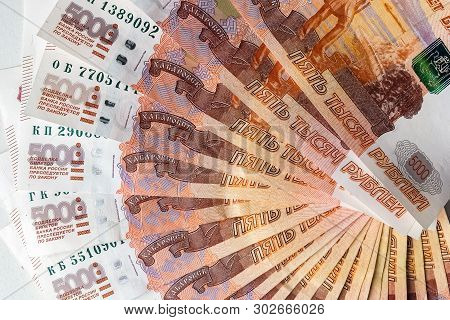 Russian Rubles Are On A Homogeneous Background, Bills Five Thousand Rubles, Money Fan In Hand