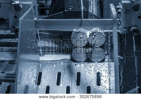 The Bandsaw Cutting Machine Cutting The Metal Shaft With The Lubricant.