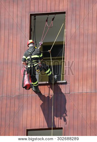 Fireman During A Fire Drill Whitel Climbs On The House