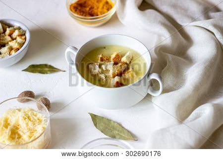 Cheese Cream Soup On A White Background. White Bread Croutons. Ingredients.