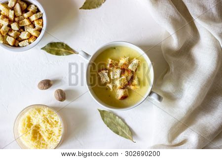 Cheese Cream Soup On A White Background. White Bread Croutons. Ingredients.