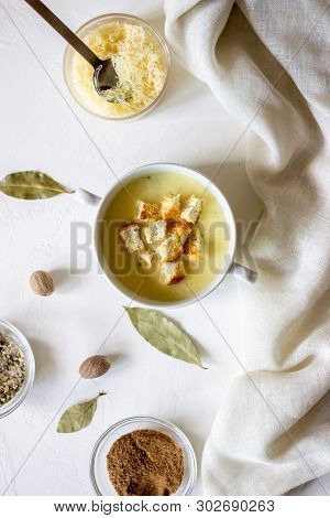 Cheese Cream Soup On A White Background. White Bread Croutons. Ingredients.