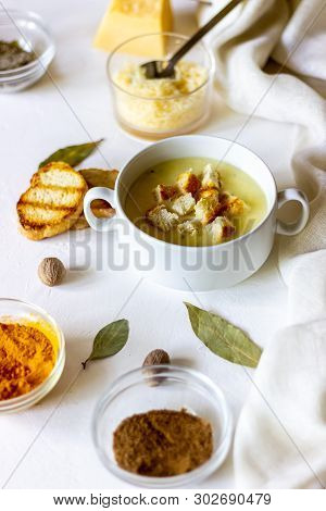 Cheese Cream Soup On A White Background. White Bread Croutons. Ingredients.