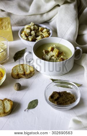 Cheese Cream Soup On A White Background. White Bread Croutons. Ingredients.