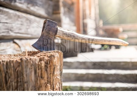 Getting Wood For Fire: Axe Attached To A Tree Trunk