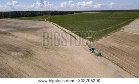 Tractor Driven Organic Fertilizer On The Field