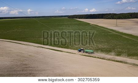 Tractor Driven Organic Fertilizer On The Field