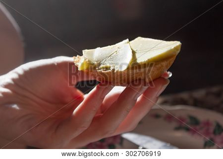 A Little Bread Crust With Butter In Hand