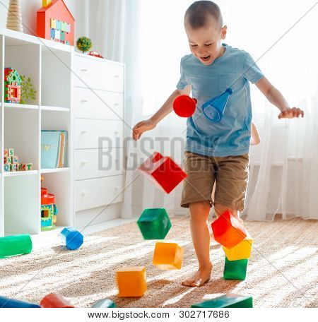Little Brother And Sister Run Around The Room Spreading Legs Toy Raznocvetnye Plastikovye Blocks. Ch