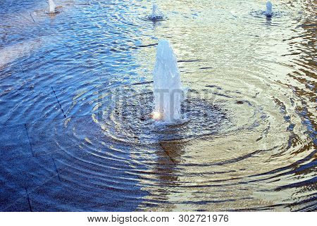 Rainbow Reflected On The Water Fountain On A Sunny Day