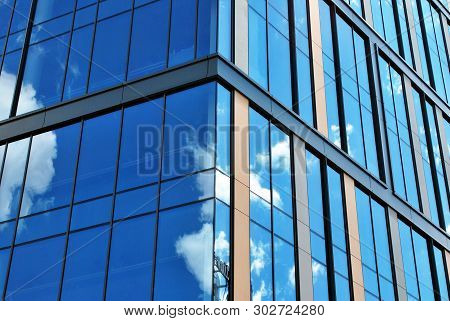 Surface Of Glass Building With The Reflection Of Clouds