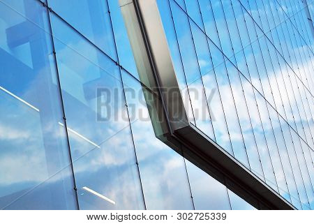 Surface Of Glass Building With The Reflection Of Clouds